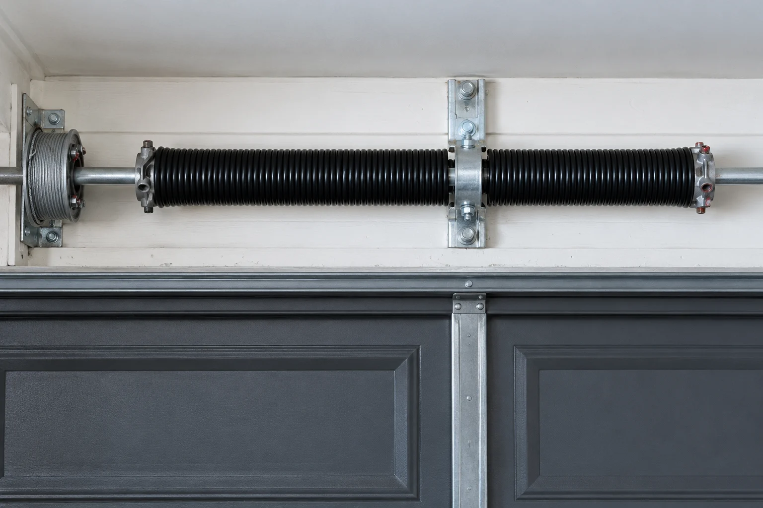 Garage door torsion spring and mounting bracket